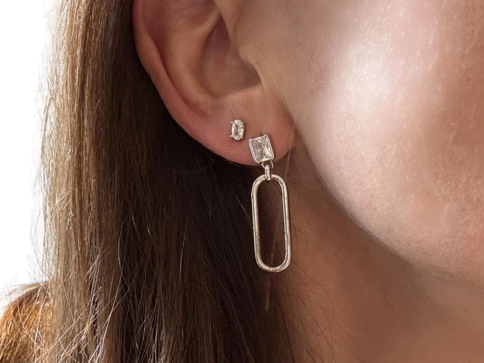 Long silver drop earring with transparent stone